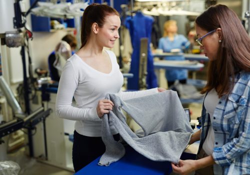 New pullover Owner of clothing restore workshop showing her client pullover